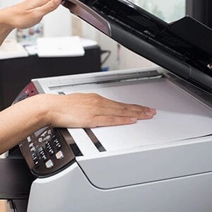 A person is using the printer to print.