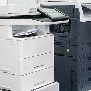 A black and white printer sitting next to each other.