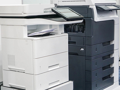 A black and white printer sitting next to each other.