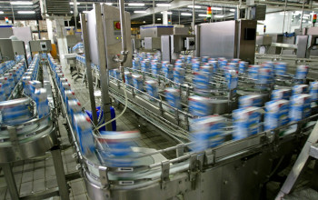A factory with many boxes of milk on the conveyer belt.
